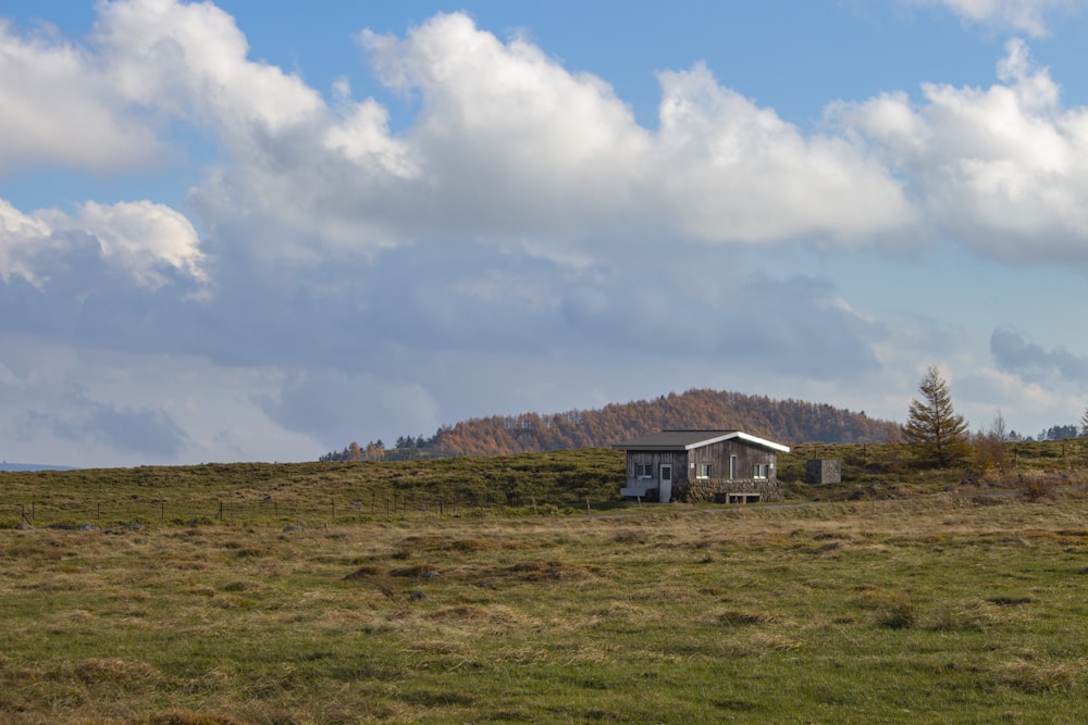 a house in a field with a mountain in the background