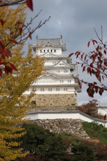 a tall white building sitting on top of a hill