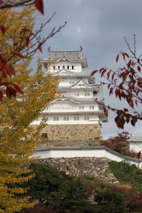 a tall white building sitting on top of a hill