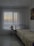 A cozy bedroom featuring soft bedding and elegant curtains.