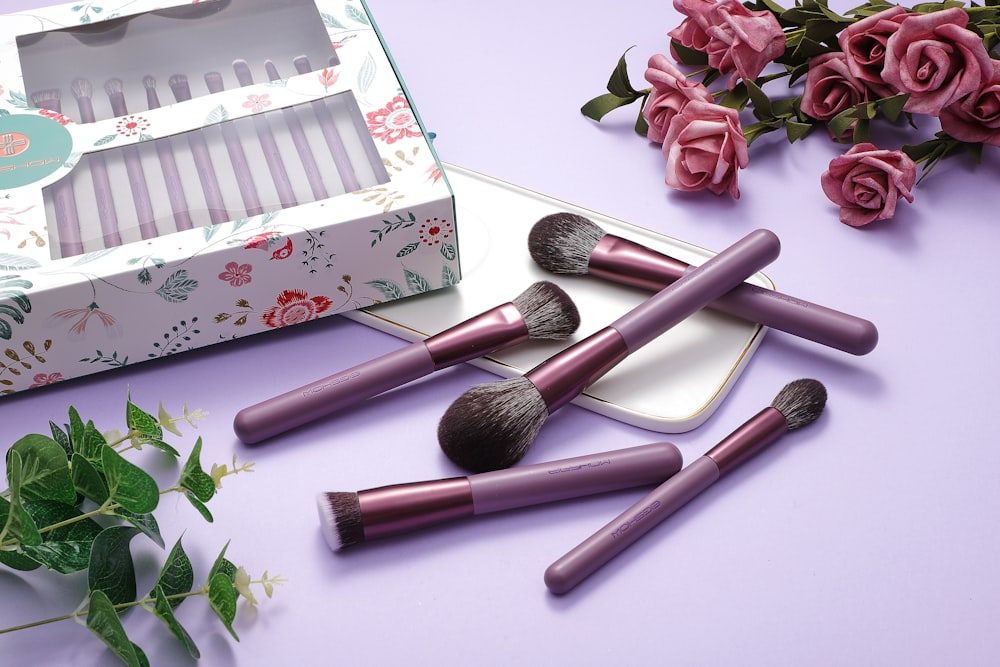 a set of five makeup brushes sitting on top of a table