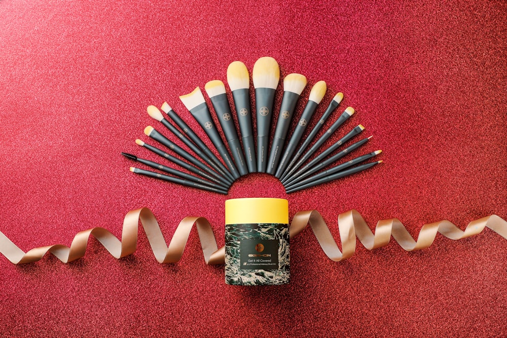 a group of makeup brushes sitting on top of a red carpet