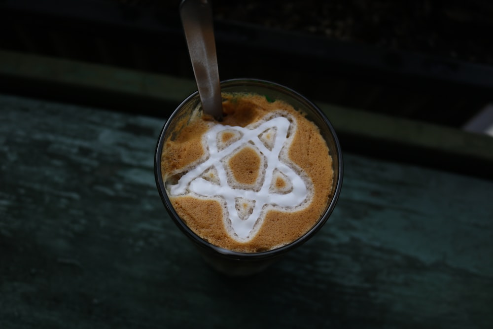 a cup of coffee with a star of david on top