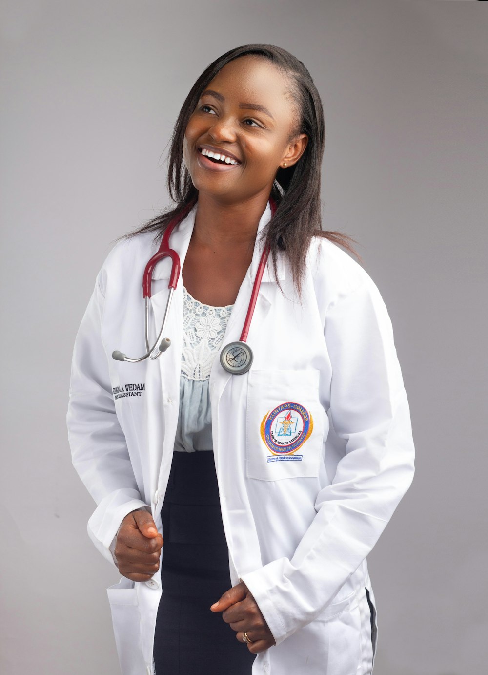 a woman wearing a white coat and a stethoscope