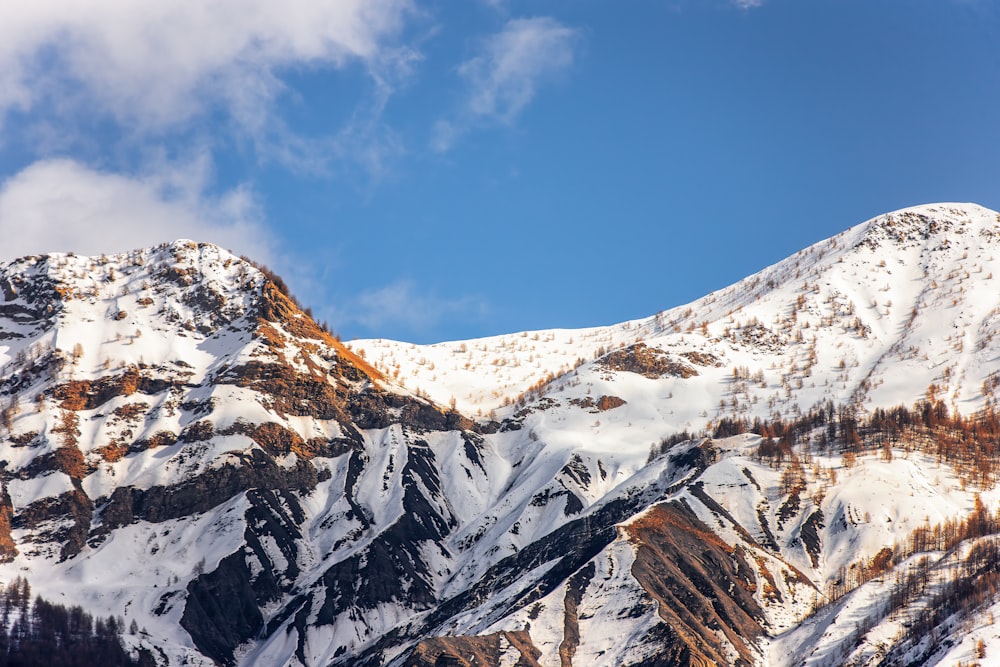 a mountain covered in snow under a blue sky