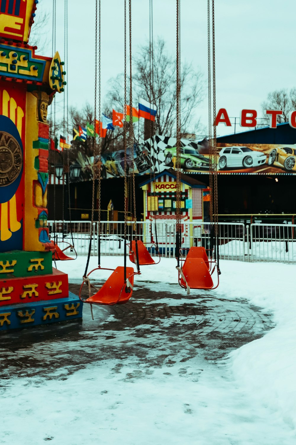 a merry go round in the middle of a snow covered park