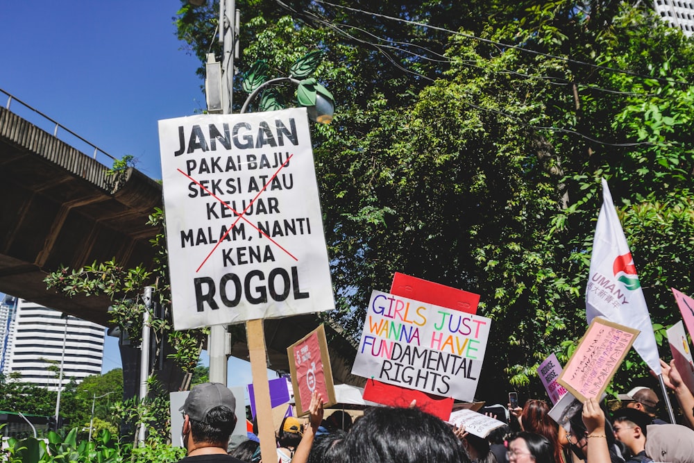 a group of people holding up signs in the air