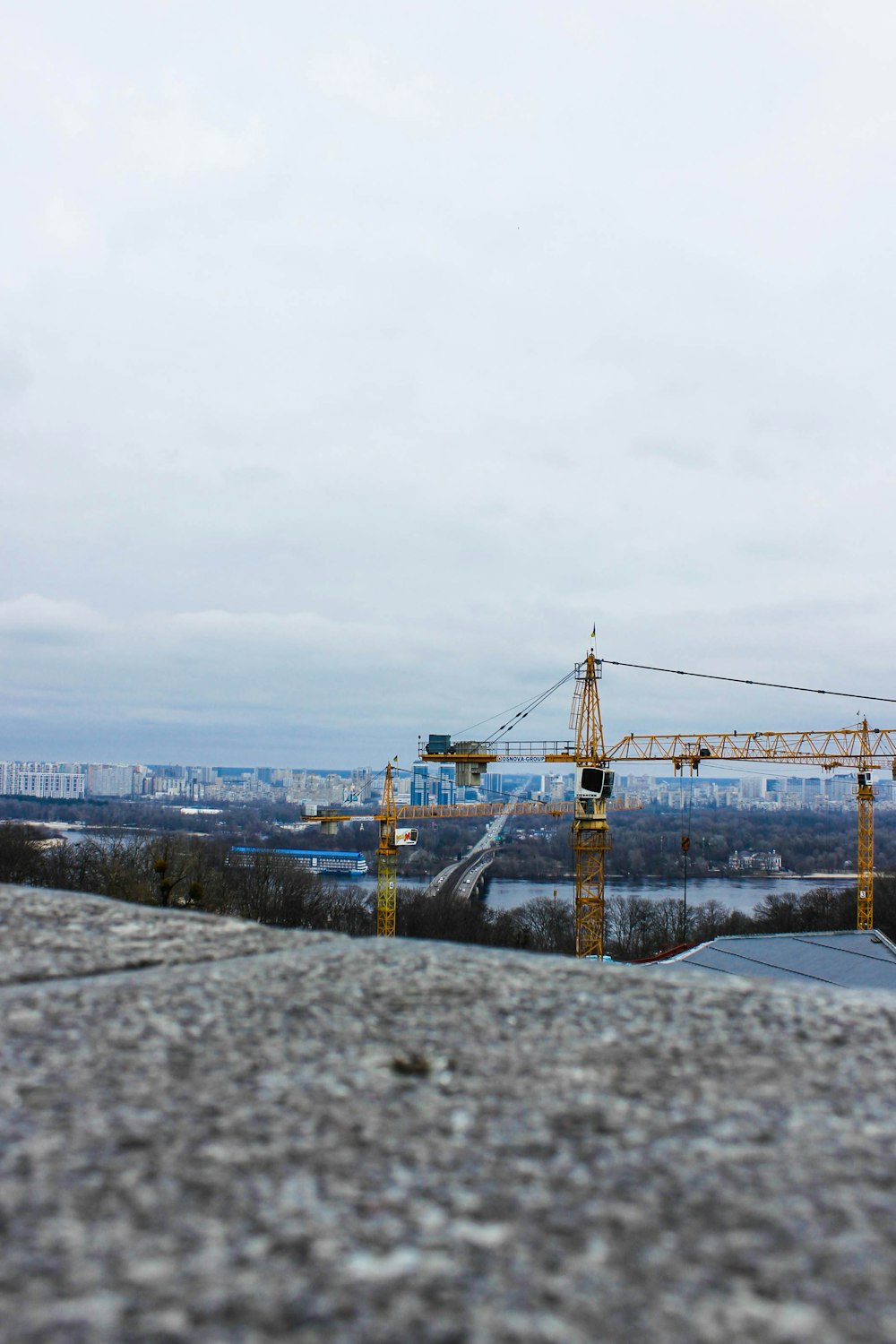 a construction site with cranes in the background