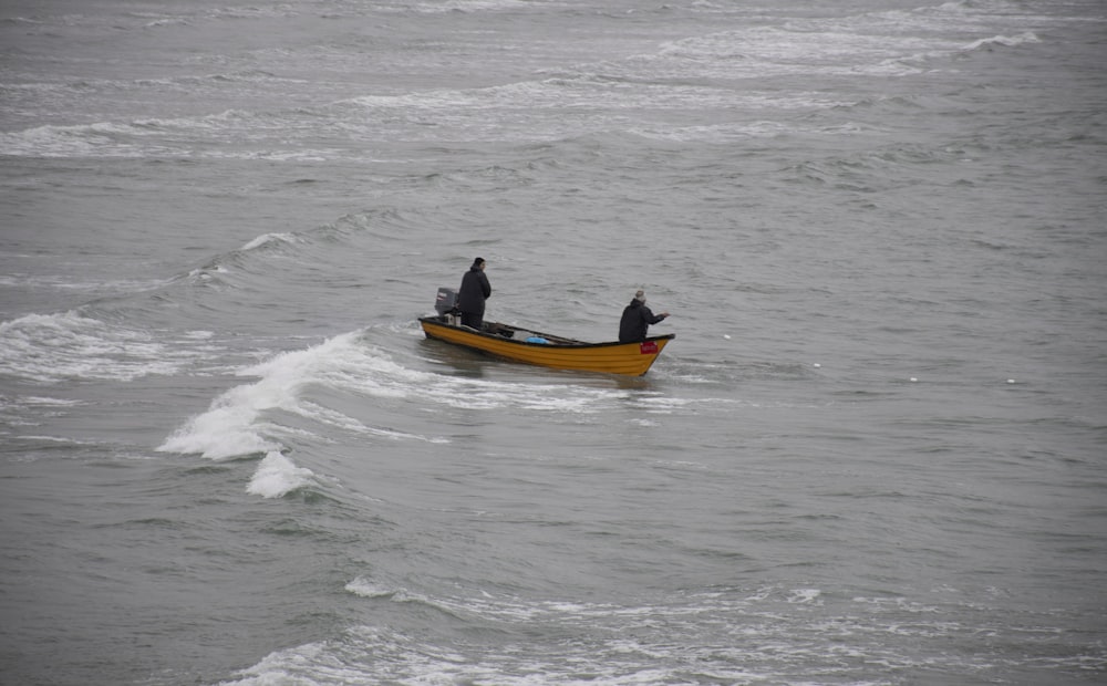 two people in a small boat in the ocean