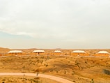 Comfortable accommodation portacabins arranged neatly with desert landscape in the background.