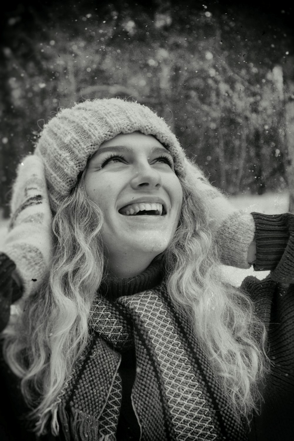 a black and white photo of a woman laughing