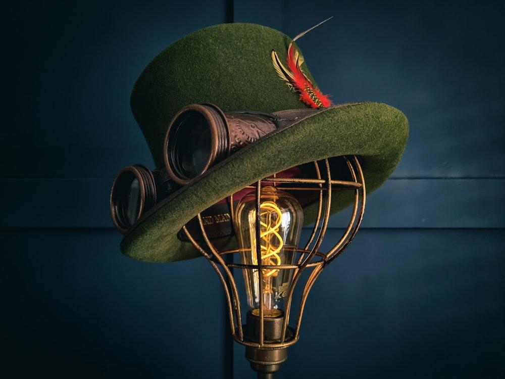 a green hat with a light bulb attached to it