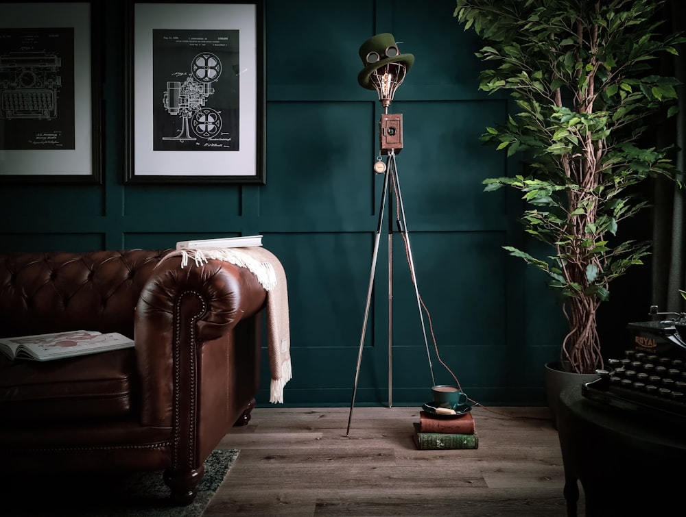 a living room with a brown couch and a green wall