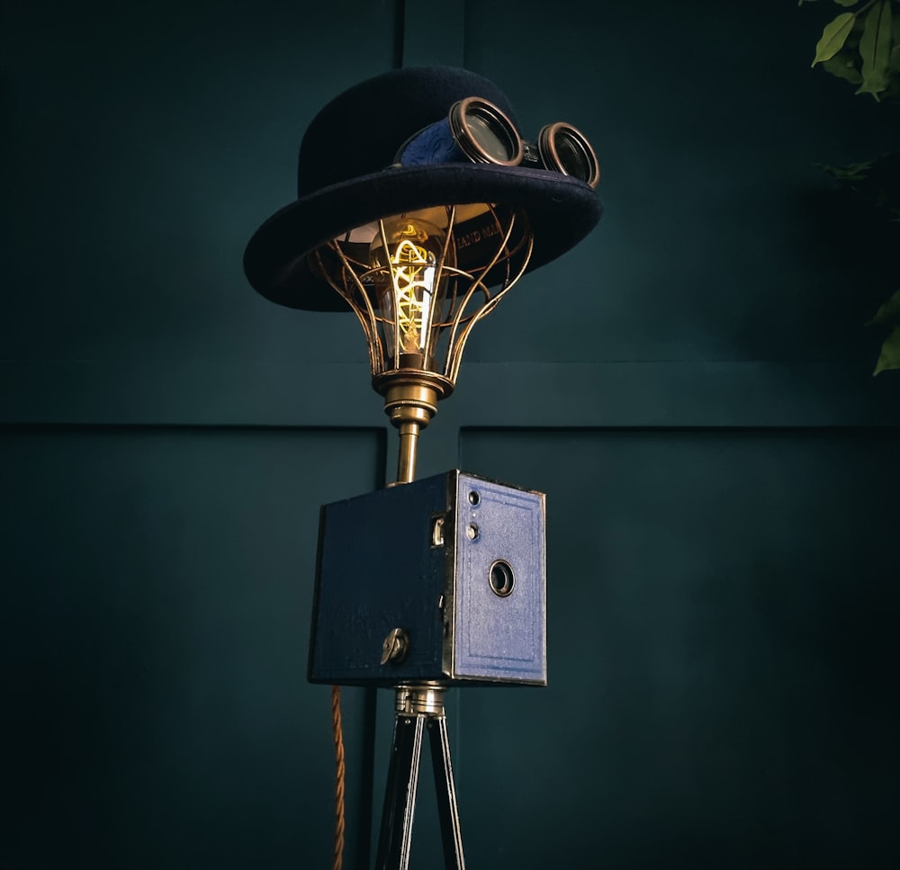 a lamp with a hat on top of it