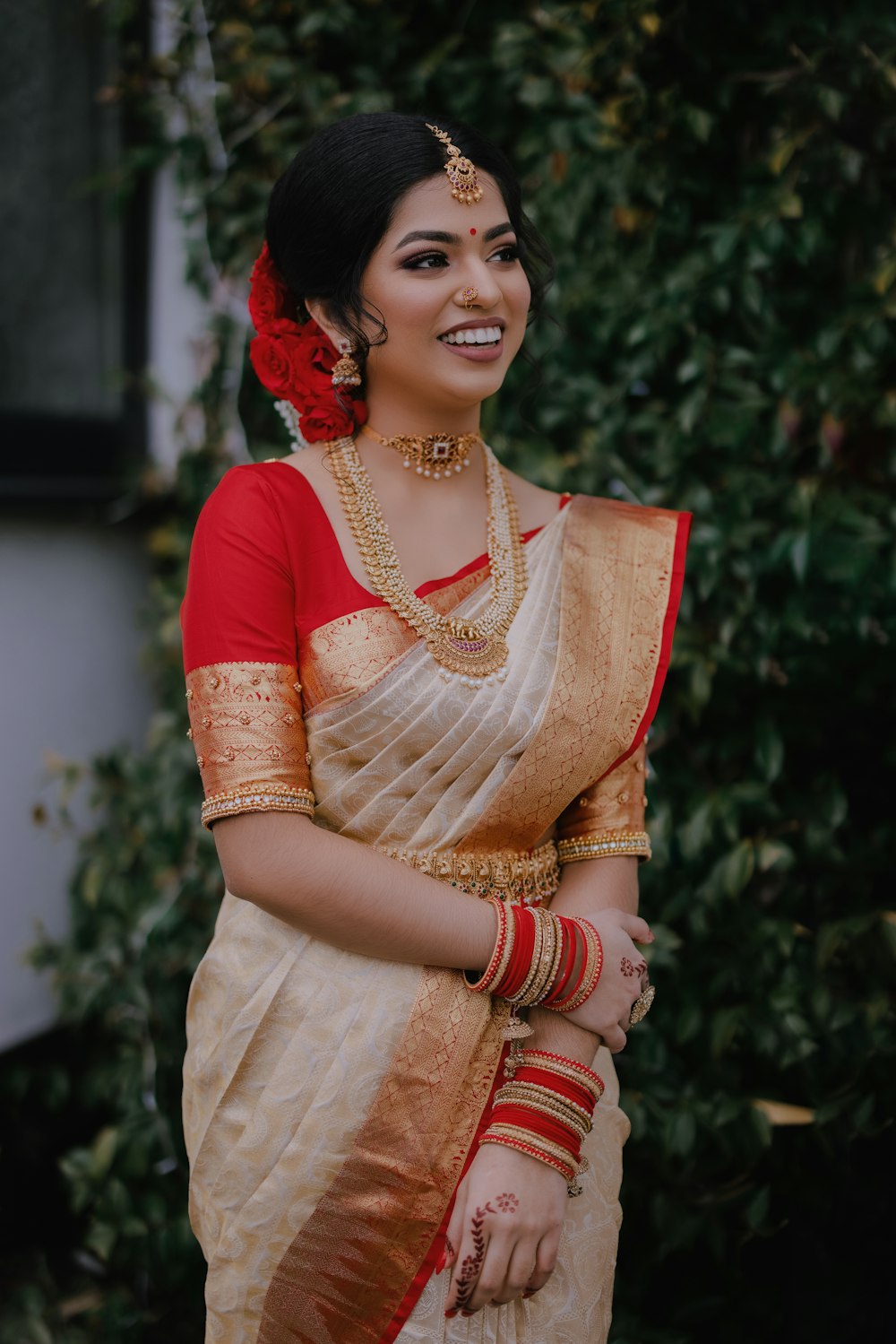 a woman in a white and red sari
