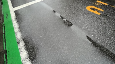 Brightly painted road markings freshly applied on a newly paved street.
