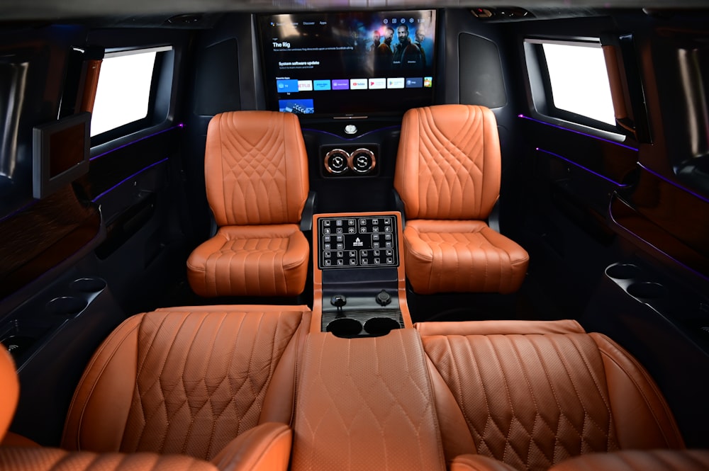 the interior of a luxury car with leather seats