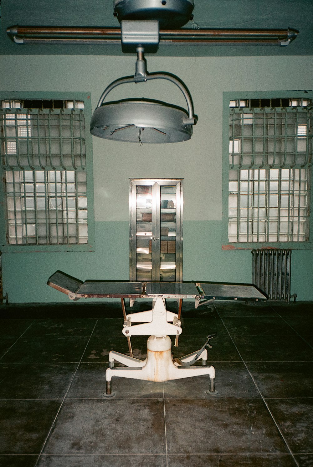 a hospital room with a hospital bed and a chair