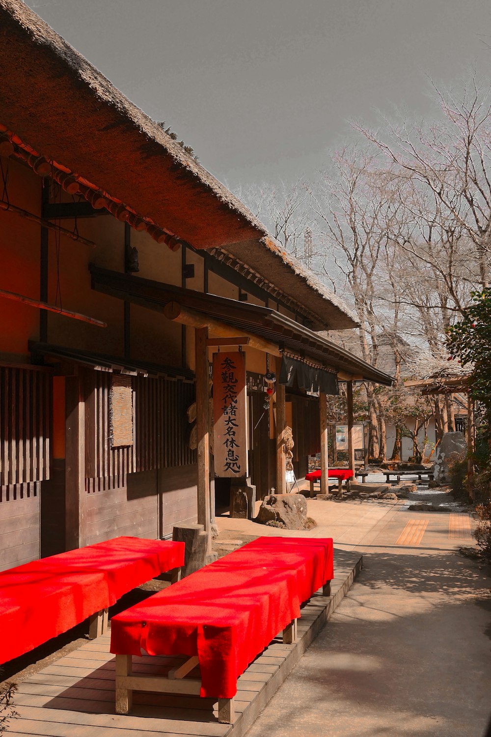 a row of red benches sitting in front of a building