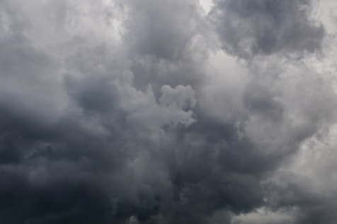 a plane is flying in the cloudy sky