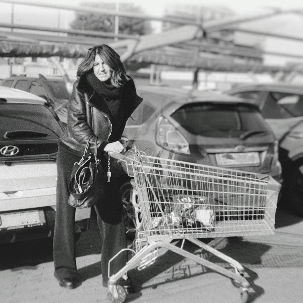 a woman standing next to a shopping cart
