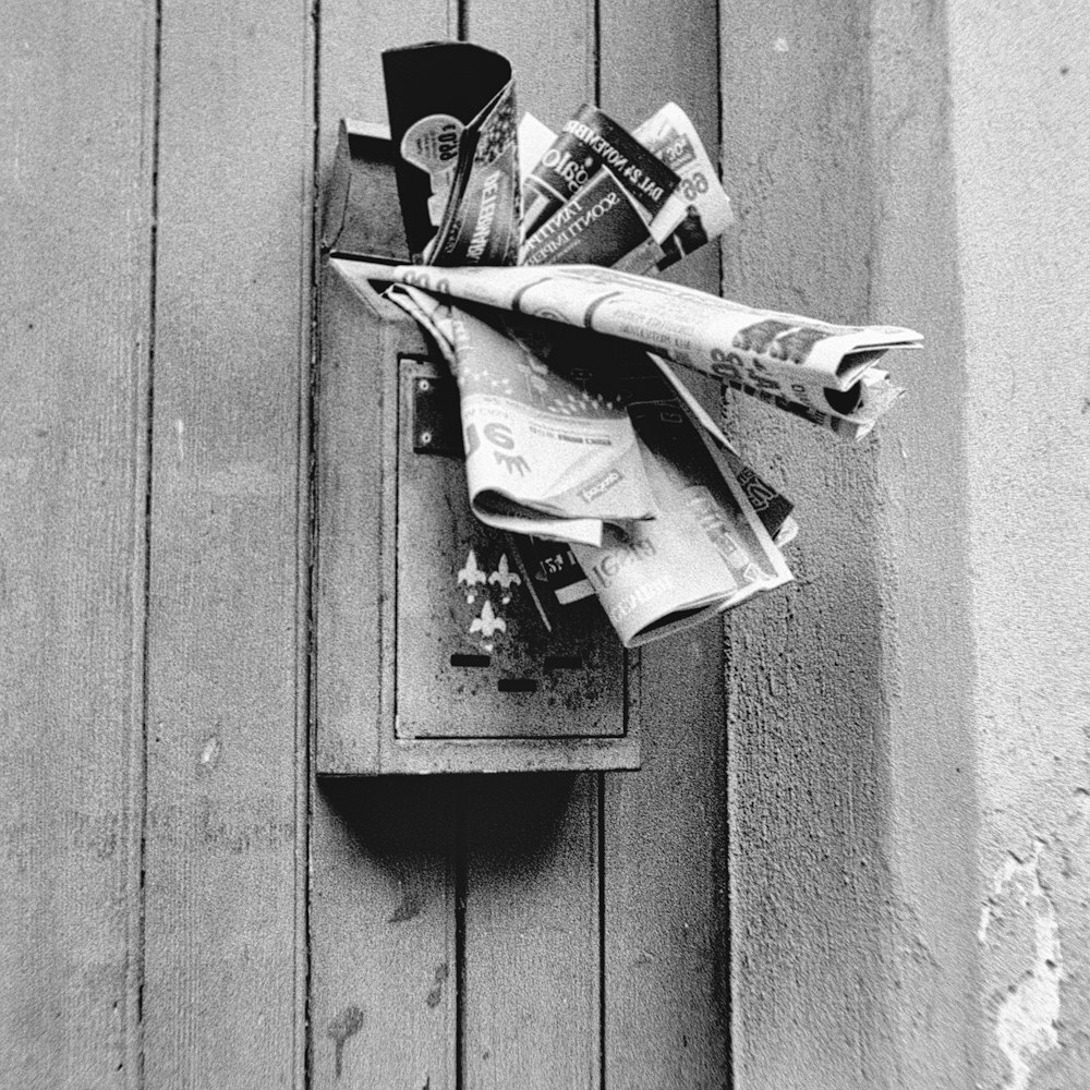 a mailbox with a bunch of newspapers sticking out of it