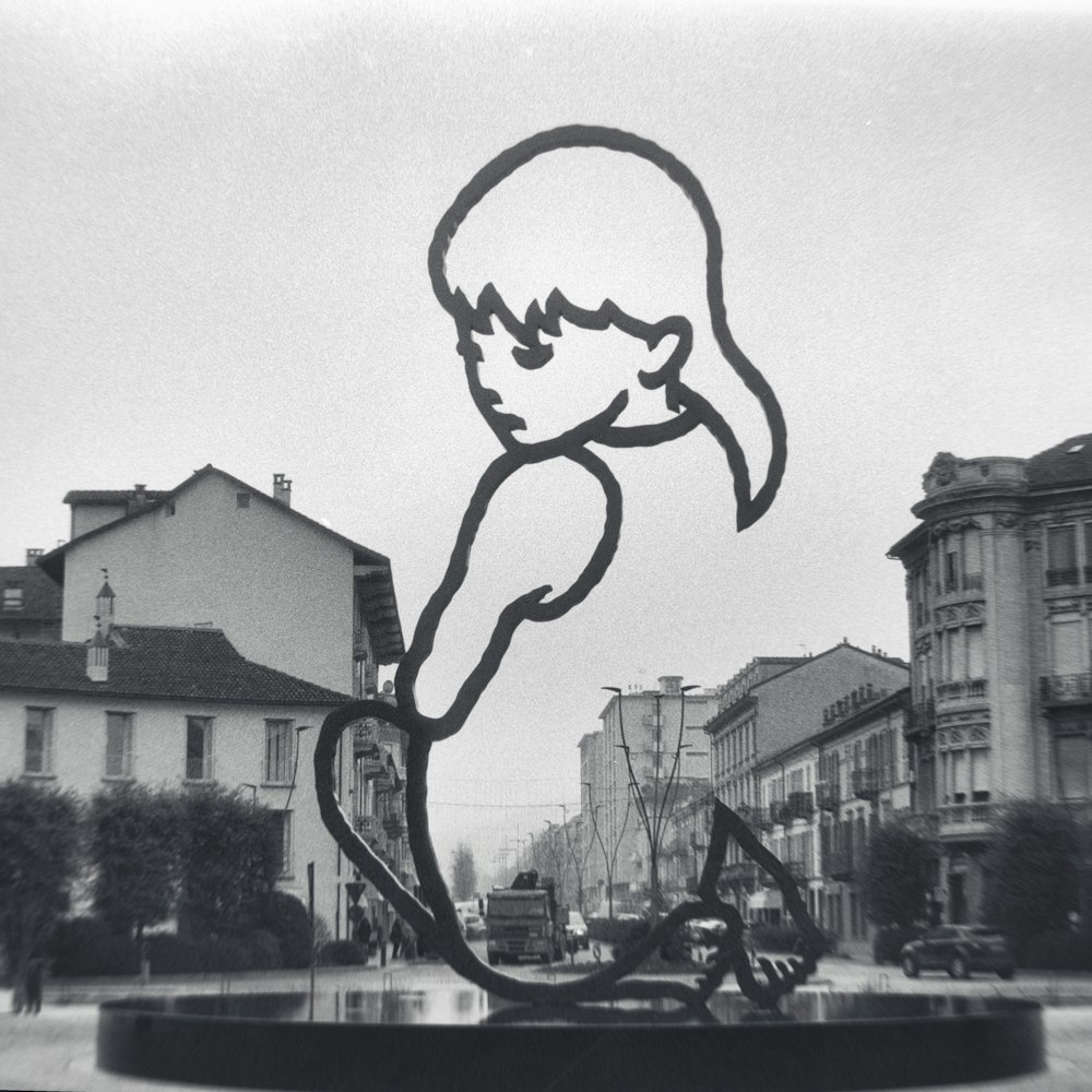 a black and white photo of a statue of a person