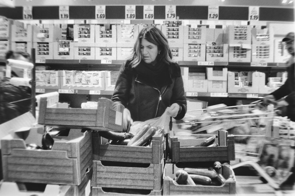 a woman standing in a store holding a box