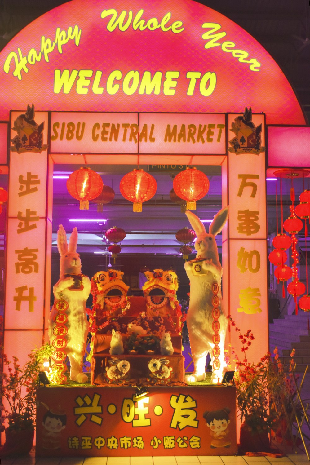 Un cartel de bienvenida a un mercado central con conejos