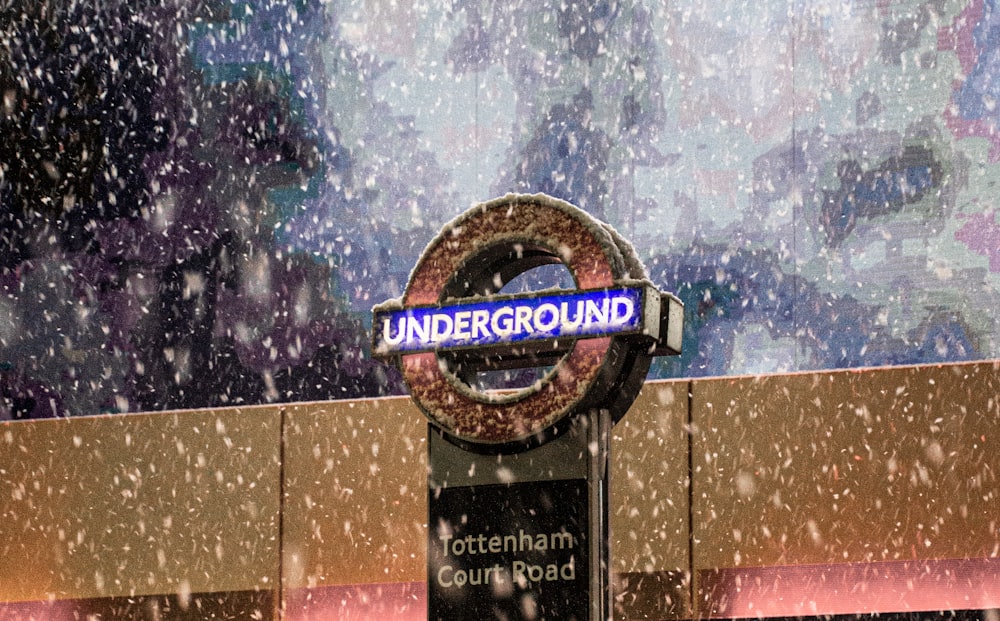 a london underground sign in the snow