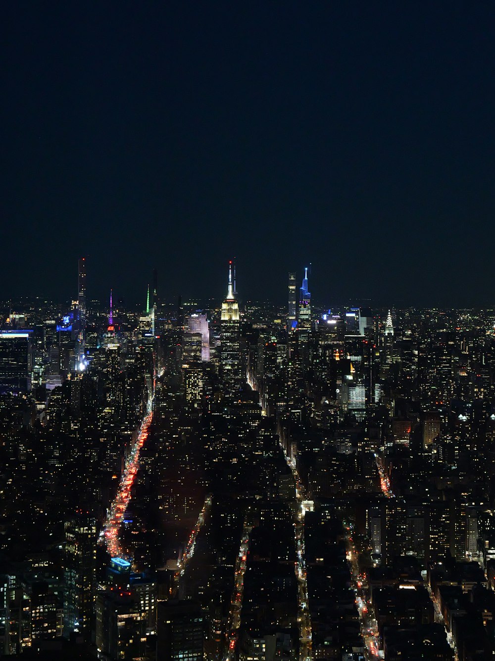 a view of a city at night from the top of a building