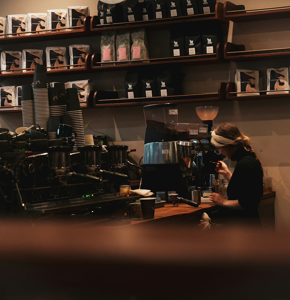 a woman is working at a coffee shop