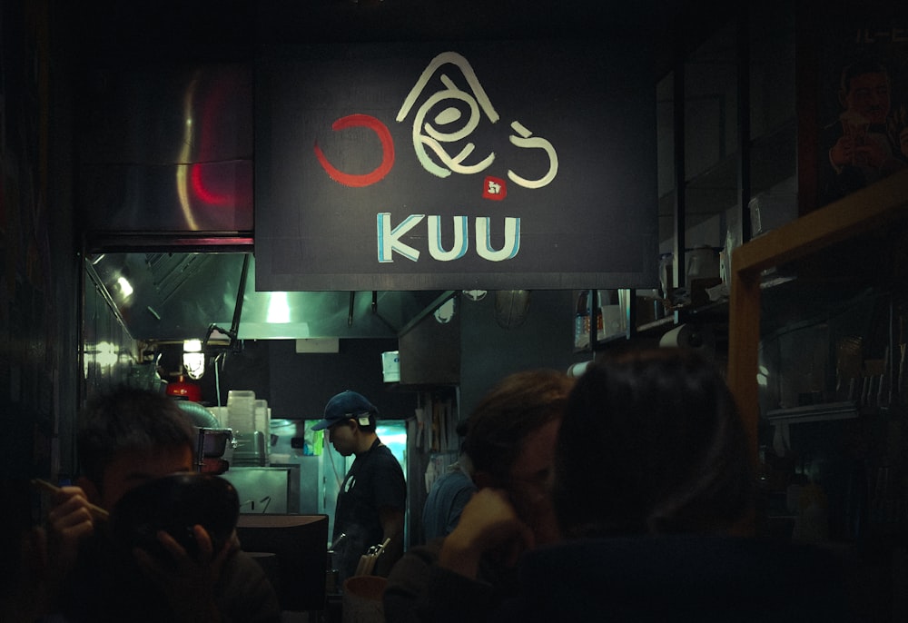 a group of people standing in front of a restaurant