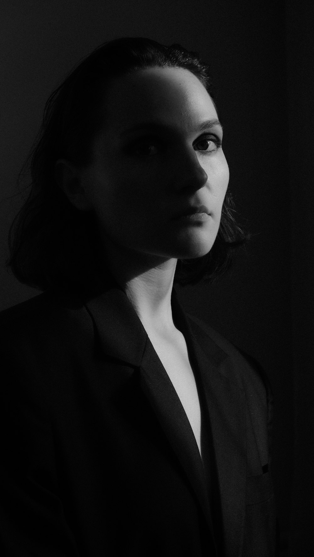 a black and white photo of a woman in a suit