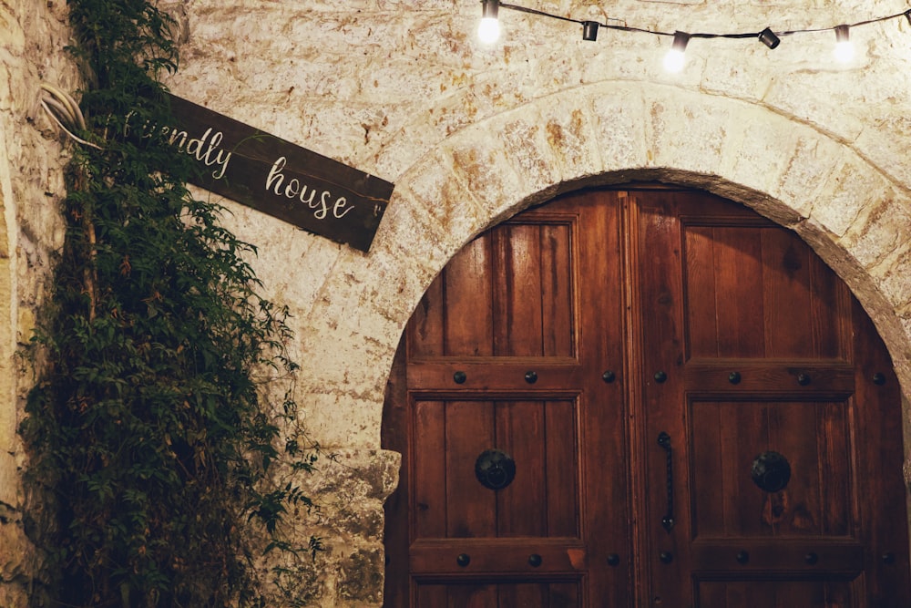 a couple of wooden doors sitting inside of a stone building