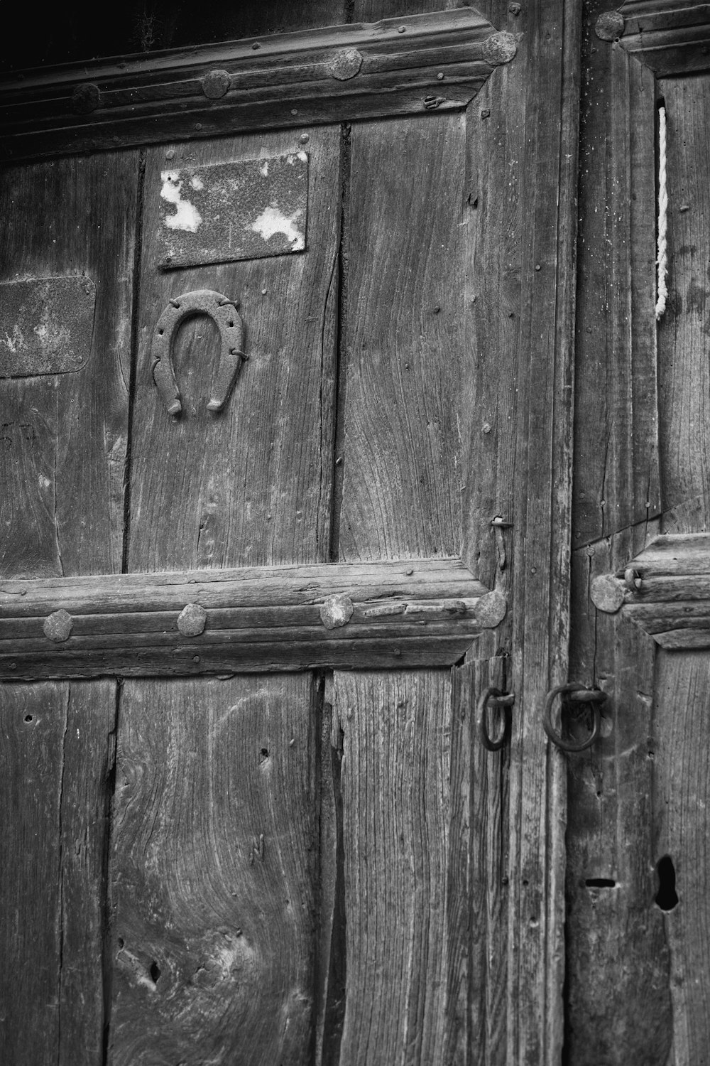 a black and white photo of a wooden door