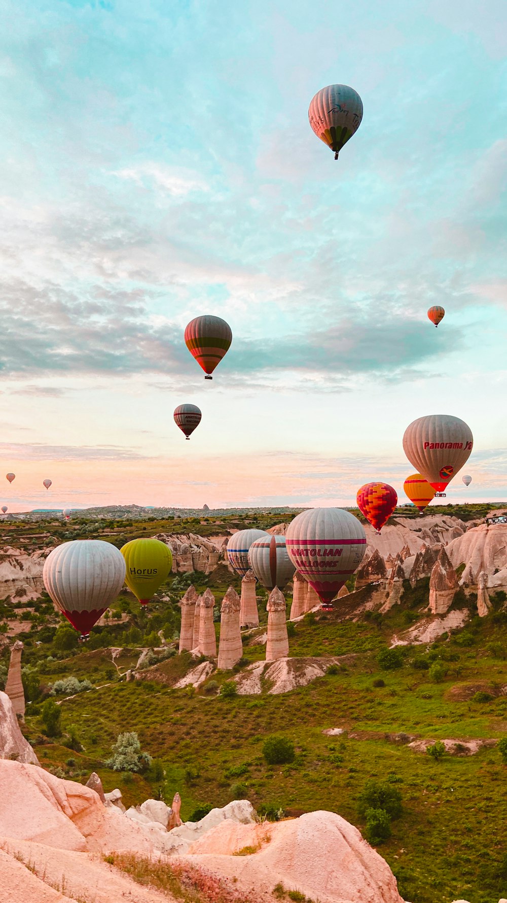 a bunch of hot air balloons flying in the sky