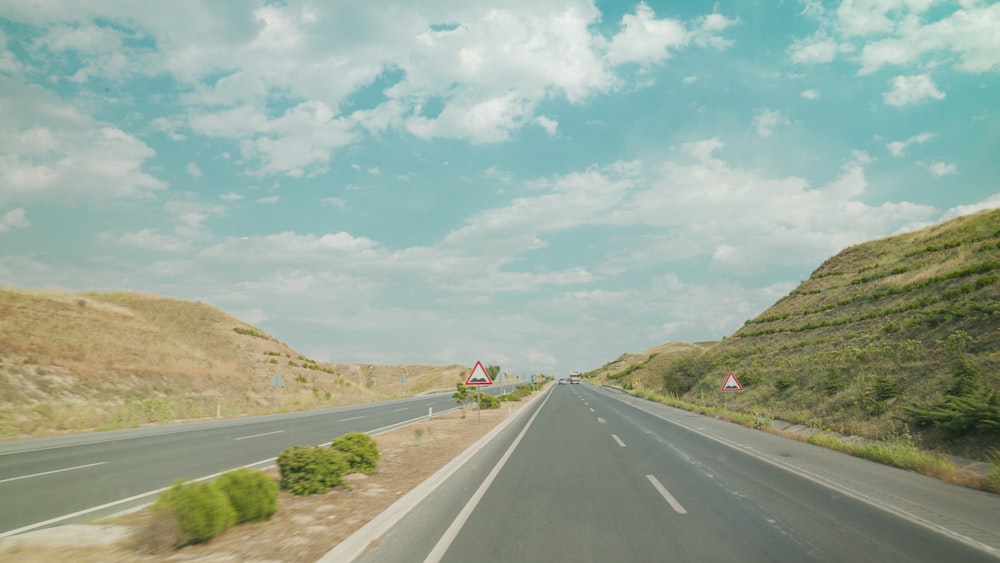 a long road with a hill in the background