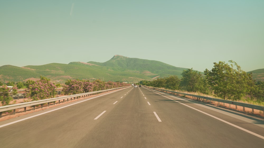 a view of a highway with mountains in the background