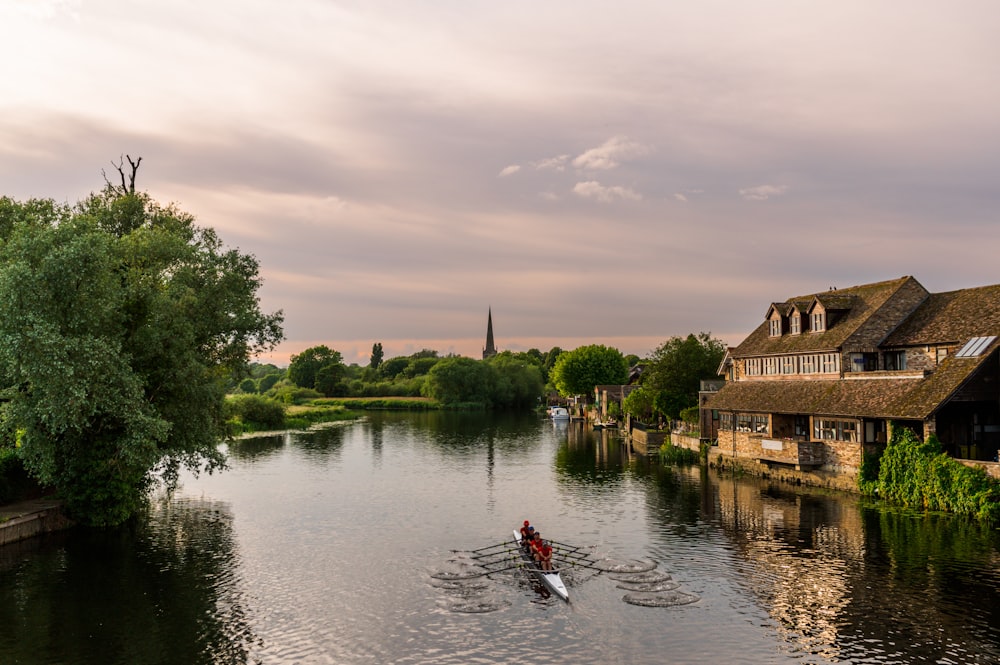 a person rowing a boat down a river