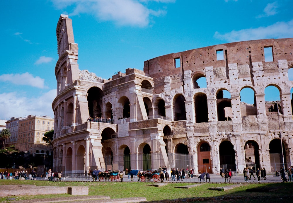 a group of people standing in front of an old building