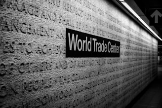 a black and white photo of a world trade center sign