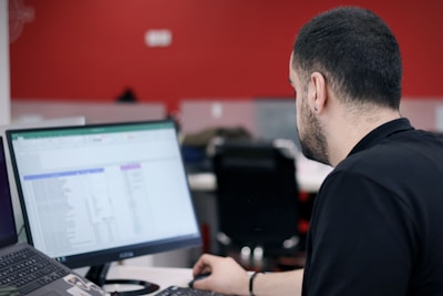 a man sitting in front of a laptop computer