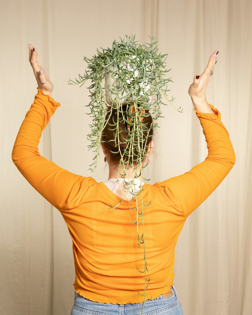 a woman with a bunch of plants on her head