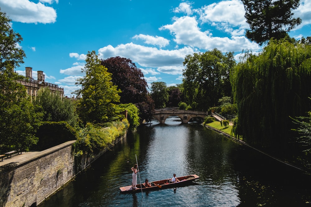 a man is rowing a boat down a river