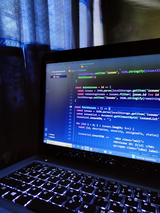Adult learner attentively coding on a laptop during a cozy evening tech class.