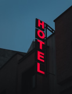 a red hotel sign on the side of a building