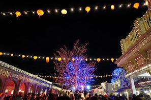 Nighttime scene of GT Village illuminated with colorful lights, capturing the festive atmosphere.