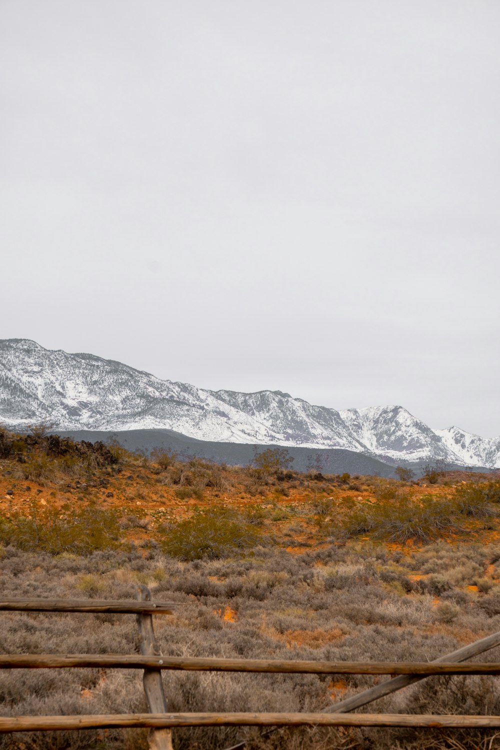 a wooden fence sitting in the middle of a field