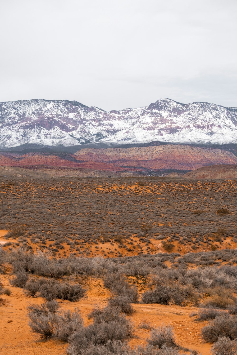 a mountain range with snow covered mountains in the background